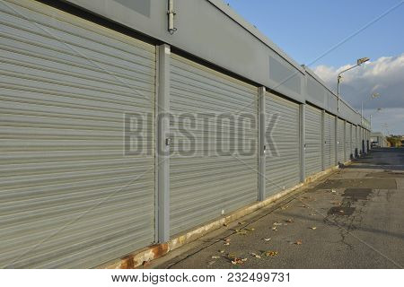 Row Of Gray Closed Containers Under The Open Sky