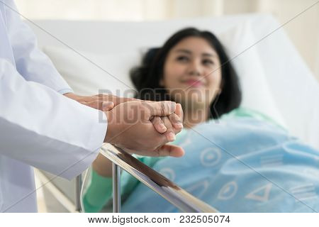 Friendly Man Doctor Hands Holding Patient Hand Sitting At The Desk For Encouragement, Empathy, Cheer