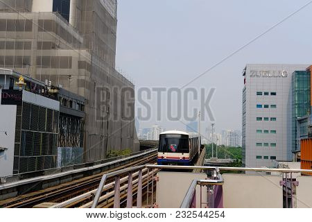 Cityscape Of Modern Office Building & Bts Sky Train Mass Transit System On Railway At Sala Daeng Sta