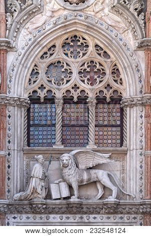 VENICE, ITALY - MAY 28, 2017 : Detail of the Porta della Carta, Doge's Palace in Venice, Italy, depicting Doge Francesco Foscari kneeling before the Lion of St. Mark, UNESCO World Heritage Sites