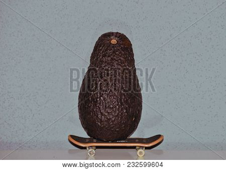 Skateboarding Green Avocado With A Grey Background
