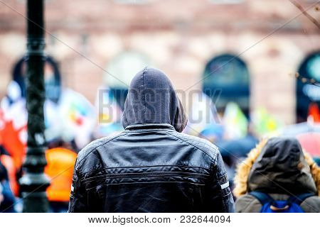 Strasbourg, France  - Mar 22, 2018: Rear View Of Surveillance Young Man Wearing Hoodie Coat At Demon