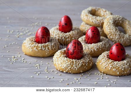 Traditional Greek Easter Cookies With Sesame Seeds And Colored Eggs On The Wooden Table, Selective F