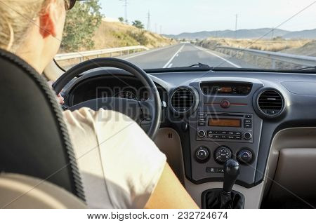 Woman Driving Calmy By Two-way Country Road At Sunset. Inside Car View
