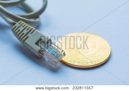 Bitcoin Gold Coin And Network Wire Connectors Patch Cord Cable. Concept Of Digital Money Transfer.