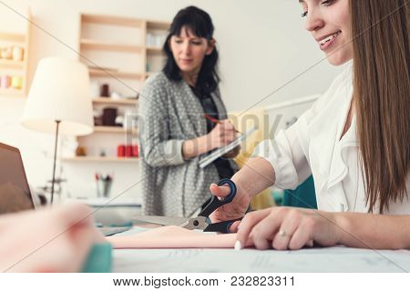 Working Process In Sewing Studio Of Two Dressmaker Women. Sew Small Business. Seamester. Team Of Clo