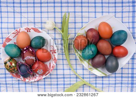 Easter Eggs On Plates And Tulip Flower