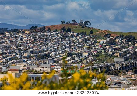 San Francisco Springtime Skyline Towards Bernal Heights Neighborhood With Blooming Yellow Flowers In