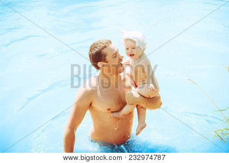Happy Family Father And Son. Dad Teaches His Son To Swim
