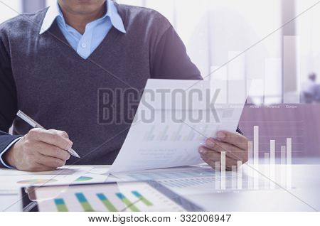 Businessman Or Accountant Working In The Office Reviewing Financial Statements For Business Performa