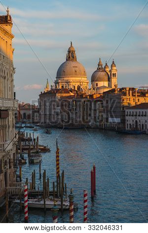 View Of The Grand Canal In Venice During Sunset. Ttraditional Gondolas And Boats With Passengers. Ba