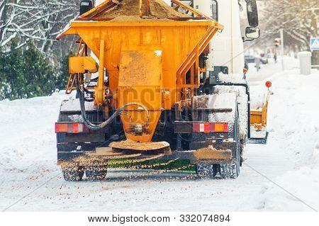 Municipal Car Sprinkles Snowy Roads With Sand And Salt. Snow Blower. Winter Anti-slip Road Handling 