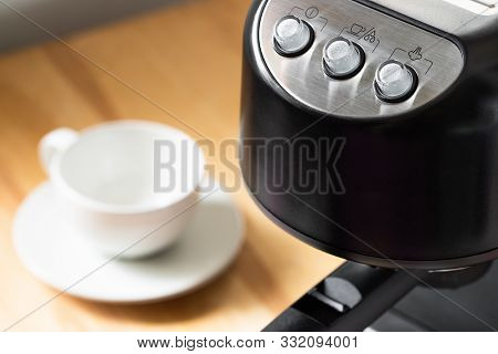 Close Up Of Black Modern Semi-automatic Coffee Maker With Buttons On Wooden Table Indoors, Top View.