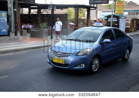 Bali, Indonesia- 18 Oct, 2019: Bali Taxi Travelling On The Street Of Bali. There Are Many Different 