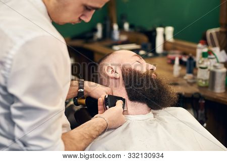 Bearded Man Client In Hairdresser Chair Throwing Back His Head During Barber Styling Clients Beard W