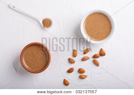 Apricot Kernel Butter Smooth, Urbech. Natural Paste From Apricot Kernels In White Bowls On White Tab