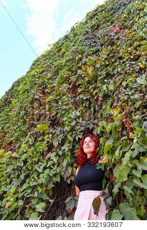 Unusual And Stylish Photo Of A Girl In The Bushes. Vertical Photo. Conceptual Foto. Solitude With Na