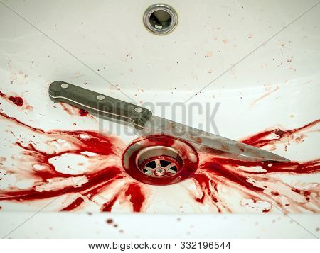 Blood Stains And Knife In Bathroom In White Ceramic Sink, Bleeding, Criminal And Suicide Concept. Sp