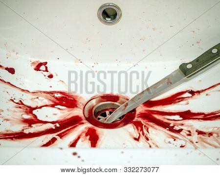 Blood Stains And Knife In Bathroom In White Ceramic Sink, Bleeding, Criminal And Suicide Concept. Sp