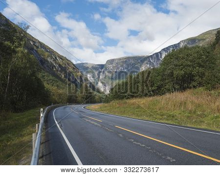 Winding Road E136 With Mountain Massif Trolltindene, Troll Wall Trollveggen, The Tallest Vertical Mo
