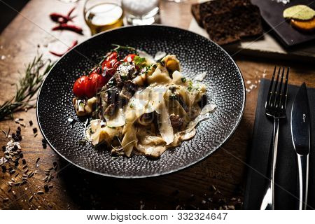Black Angus pappardelle pasta with beef, champignon and parmegano cheese