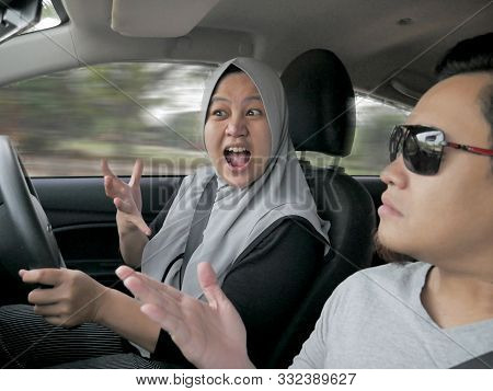 Portrait Of Muslim Car Female Driver Having Fight Argue With Husband Passanger In Car, Temperamental
