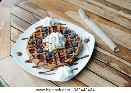 Plate Of Belgian Waffles With Ice Cream, Chocolate Sauce And Fresh Berries