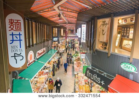 KANAZAWA, JAPAN - JANUARY 20, 2017: Early morning shoppers peruse fresh seafood at the the Omicho Market.