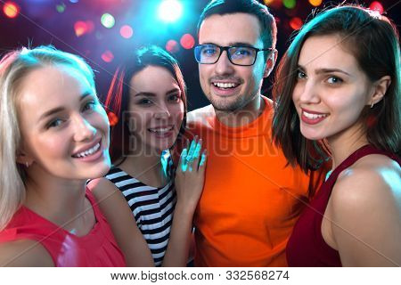Group of happy young people having fun at party.