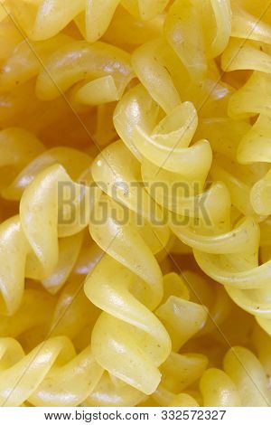 Traditional Italian pasta close-up. Twisted in a spiral paste. Delicious and healthy food. Close-up.