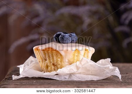 Muffin With Bluberry Decorated With Lavender On Rustic Old Wooden Bench Against Of Dark Background