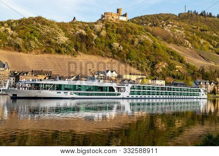 View At The City Of Bernkastel-kues At River Moselle With Passenger Ships And Mountains With Vineyar