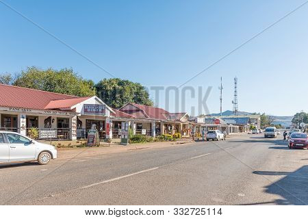 Graskop, South Africa - May 20, 2019: A Street Scene, With Businesses, Vehicles And People, In Grask