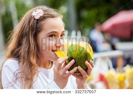 Beautiful Young Girl At Paseo Bolivar Square In The City Of Cali Eating Tropical Fruits In Colombia