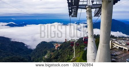 Cable Car At Genting Highlands, Malaysia In A Foggy Weather With Green Grass Visible From Inside Cab