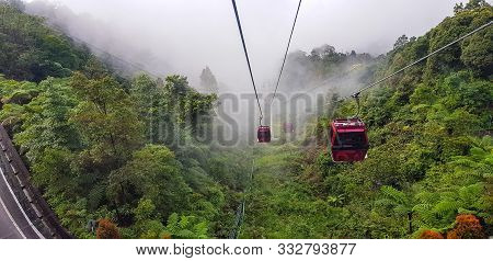 Cable Car At Genting Highlands, Malaysia In A Foggy Weather With Green Grass Visible From Inside Cab