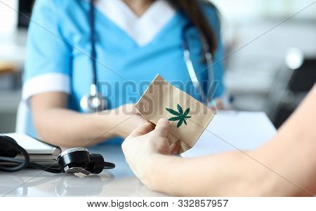 Female Doctor Writes Prescription For Medical Marijuana To Patient In Hospital Office. Legal Marijua