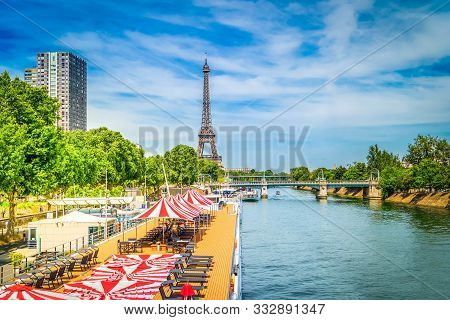 Paris Beach At Summer. Eiffel Tower With Moden Houses Over Seine River, Paris, France, Toned