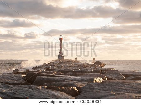 Scusset Light At The End Of A Jetty With Fishermen
