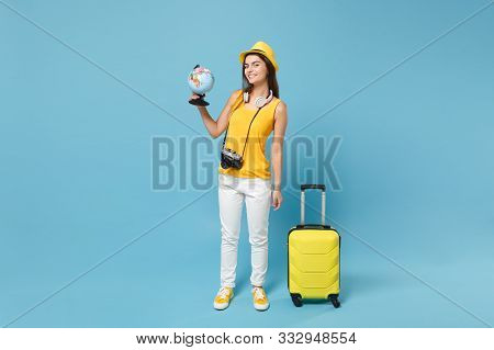 Traveler Tourist Woman In Yellow Casual Clothes, Hat With Suitcase Photo Camera Isolated On Blue Bac