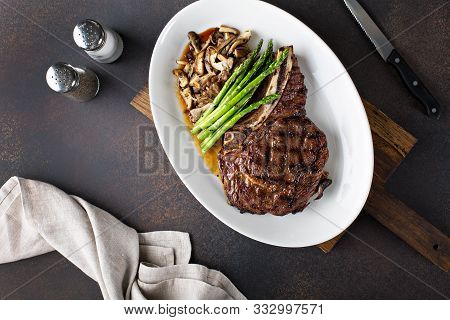 Bone-in Ribeye Beef Steak With Mushrooms And Asparagus