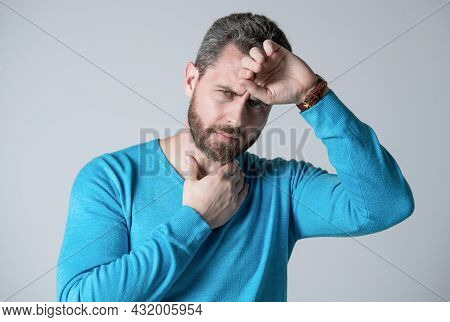 Mature Man With Beard Has Heacache Suffer From Headahce On Grey Background, Malaise