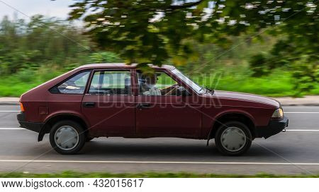 Azlk 2141 Moskvich Car Rides On A Street. Maroon Color Vintage Hatchback Motor Car Rushes On The Cou
