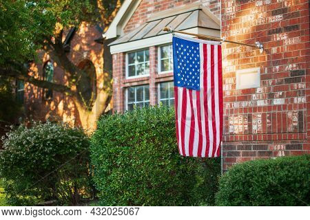 American Flag Flying At Half-staff Of A Residential Home.