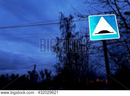 Traffic Sign Indicating Something That Slows Down, At Sunset