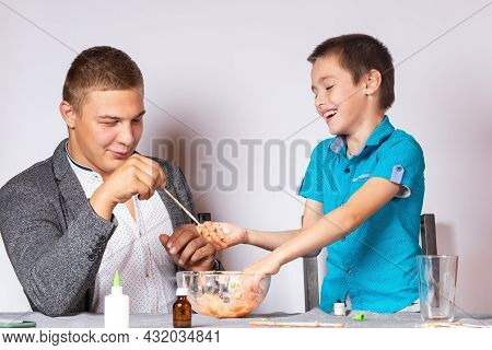 Chemistry Education And Training Concept. Close-up Of A Boy And His Dad Doing A Home Chemical Experi