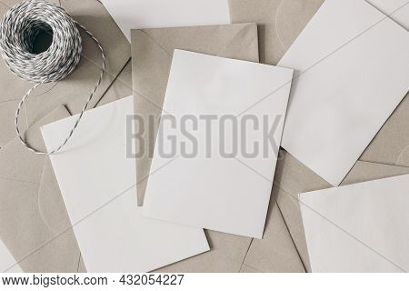 Pile Of Blank Letters With Craft Envelopes And Decorative Rope On Table. Closeup Of Empty Greeting C