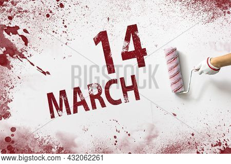 March 14th. Day 14 Of Month, Calendar Date. The Hand Holds A Roller With Red Paint And Writes A Cale
