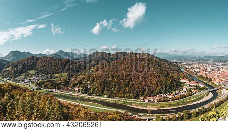 Aerial Panoramic Autumn View To The City Celje In Slovenia. Autumn Trees, Green Meadows And Red Roof