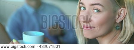 Portrait Of Smiling Woman With Cup At Meeting In Cafe